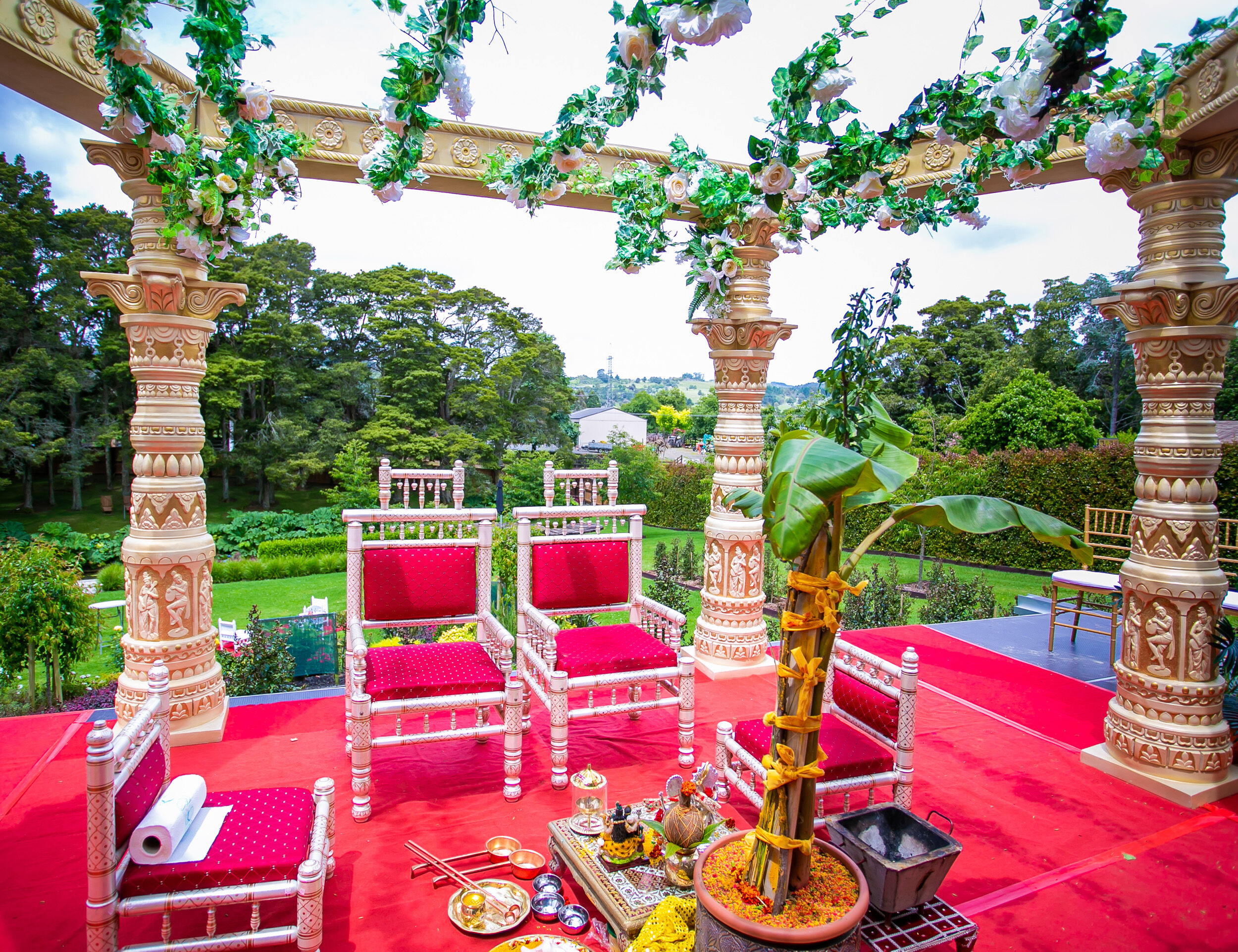 Wedding mandap with natural green background and elegant décor